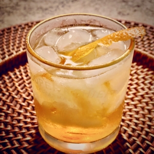 cocktail over ice with orange rind twist